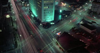 Movie still from “Koyaanisqatsi” (1982), directed by Godfrey Reggio – An aerial view of an intersection at night; Extreme Wide shot, High angle