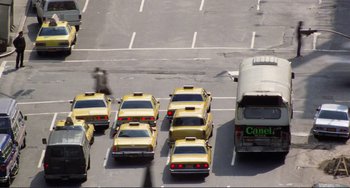 Movie still from “Koyaanisqatsi” (1982), directed by Godfrey Reggio – Many yellow taxis are lined up in a parking lot; Extreme Wide shot, High angle