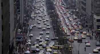 Movie still from “Koyaanisqatsi” (1982), directed by Godfrey Reggio – A street filled with lots of traffic and lots of cars on it; Extreme Wide shot, High angle
