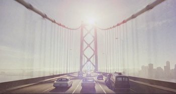 Movie still from “Koyaanisqatsi” (1982), directed by Godfrey Reggio – Cars are driving on a bridge in the middle of the day; Extreme Wide shot, Low angle