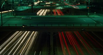 A night time view of a highway with a lot of traffic