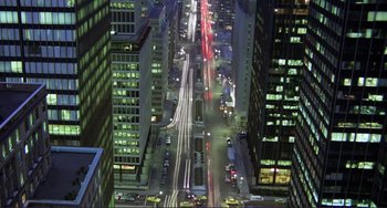Movie still from “Koyaanisqatsi” (1982), directed by Godfrey Reggio – An aerial view of a busy city street at night; Extreme Wide shot, High angle