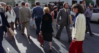 Movie still from “Koyaanisqatsi” (1982), directed by Godfrey Reggio – A crowd of people walking down a street; Wide shot, High angle