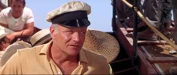Movie still from “Krakatoa: East of Java” (1968), directed by Bernard L. Kowalski – A person wearing a hat; Close Up shot, Low angle
