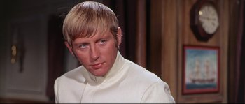 Movie still from “Krakatoa: East of Java” (1968), directed by Bernard L. Kowalski – A person wearing a white shirt; Close Up shot, Over the shoulder angle