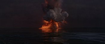 Movie still from “Krakatoa: East of Java” (1968), directed by Bernard L. Kowalski – An explosion is seen from the water at night; Extreme Wide shot, Low angle