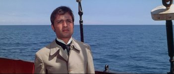 Movie still from “Krakatoa: East of Java” (1968), directed by Bernard L. Kowalski – A man standing on a boat in the ocean; Close Up shot, Low angle