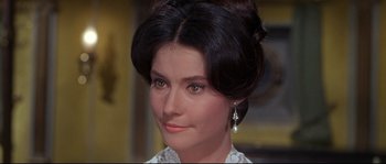 Movie still from “Krakatoa: East of Java” (1968), directed by Bernard L. Kowalski – A person wearing a white dress; Close Up shot, Over the shoulder angle