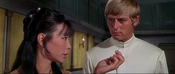 Movie still from “Krakatoa: East of Java” (1968), directed by Bernard L. Kowalski – A man and a woman looking at each other; Close Up shot, Over the shoulder angle