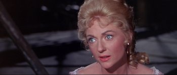 Movie still from “Krakatoa: East of Java” (1968), directed by Bernard L. Kowalski – A person wearing a dress; Close Up shot, Over the shoulder angle