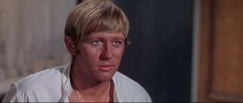 Movie still from “Krakatoa: East of Java” (1968), directed by Bernard L. Kowalski – A person wearing a white shirt; Close Up shot, Over the shoulder angle