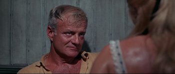 Movie still from “Krakatoa: East of Java” (1968), directed by Bernard L. Kowalski – A person looking at a mirror; Close Up shot, Over the shoulder angle