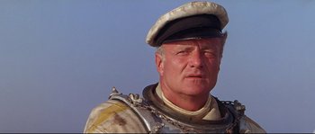 Movie still from “Krakatoa: East of Java” (1968), directed by Bernard L. Kowalski – A person wearing a hat; Close Up shot, Low angle