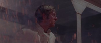 Movie still from “Krakatoa: East of Java” (1968), directed by Bernard L. Kowalski – A person wearing a white shirt; Close Up shot, Low angle