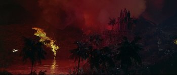 Movie still from “Krakatoa: East of Java” (1968), directed by Bernard L. Kowalski – A fire is burning in the middle of the night; Extreme Wide shot, High angle