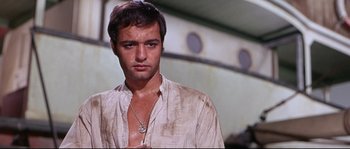 Movie still from “Krakatoa: East of Java” (1968), directed by Bernard L. Kowalski – A person wearing a white shirt; Close Up shot, Low angle