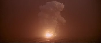 Movie still from “Krakatoa: East of Java” (1968), directed by Bernard L. Kowalski – A large cloud of smoke coming out of the ocean at night; Extreme Wide shot, Low angle