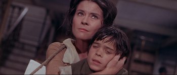 Movie still from “Krakatoa: East of Java” (1968), directed by Bernard L. Kowalski – A woman and a young boy are looking into the distance; Close Up shot, High angle