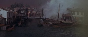 Movie still from “Krakatoa: East of Java” (1968), directed by Bernard L. Kowalski – A painting of boats in the water at night; Extreme Wide shot, High angle