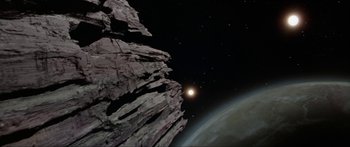 Movie still from “Krull” (1983), directed by Peter Yates – An image of an earth and a moon in the night sky; Extreme Wide shot, Low angle