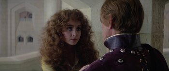 Movie still from “Krull” (1983), directed by Peter Yates – A woman with long curly hair looking into a mirror; Close Up shot, Over the shoulder angle
