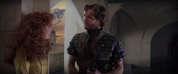 Movie still from “Krull” (1983), directed by Peter Yates – A man in a leather jacket is holding a gun in his hand; Medium shot, Over the shoulder angle