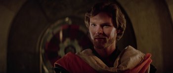 Movie still from “Krull” (1983), directed by Peter Yates – A man with long hair and a beard wearing a robe; Close Up shot, Over the shoulder angle