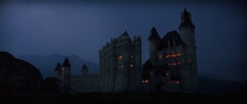 Movie still from “Krull” (1983), directed by Peter Yates – A large castle with a castle like structure on top of it; Extreme Wide shot, Low angle