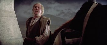 Movie still from “Krull” (1983), directed by Peter Yates – An old man in a robe and a beard on a horse; Medium shot, Low angle