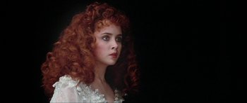 Movie still from “Krull” (1983), directed by Peter Yates – A beautiful young lady with red curly hair and blue eyes; Close Up shot, Over the shoulder angle