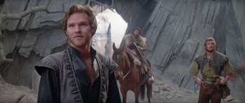 Movie still from “Krull” (1983), directed by Peter Yates – Two men on horses in a city setting; Medium shot, Low angle