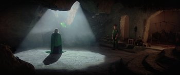 Movie still from “Krull” (1983), directed by Peter Yates – A man and a woman are in a cave; Wide shot, High angle