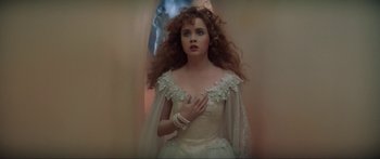 Movie still from “Krull” (1983), directed by Peter Yates – A woman in a wedding dress standing in front of a mirror; Close Up shot, Low angle