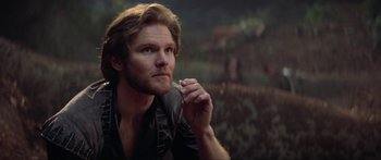 Movie still from “Krull” (1983), directed by Peter Yates – A person holding something in his hand; Close Up shot, Over the shoulder angle