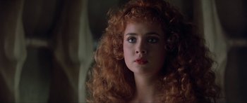 Movie still from “Krull” (1983), directed by Peter Yates – A person with curly hair; Close Up shot, Low angle