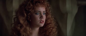 Movie still from “Krull” (1983), directed by Peter Yates – A person with curly hair; Close Up shot, Over the shoulder angle