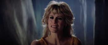 Movie still from “Krull” (1983), directed by Peter Yates – A person with long blonde hair; Close Up shot, Low angle