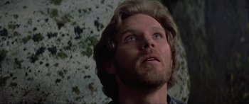 Movie still from “Krull” (1983), directed by Peter Yates – A person with long hair looking up; Close Up shot, Low angle