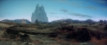 Movie still from “Krull” (1983), directed by Peter Yates – An image of an alien landscape with mountains in the background; Extreme Wide shot, Low angle