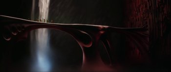 Movie still from “Krull” (1983), directed by Peter Yates – A man standing on top of a table in a dark room; Extreme Wide shot, High angle