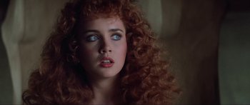 Movie still from “Krull” (1983), directed by Peter Yates – A person with curly hair; Close Up shot, Over the shoulder angle