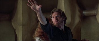 Movie still from “Krull” (1983), directed by Peter Yates – A man and a woman are standing in front of a wall; Close Up shot, Low angle