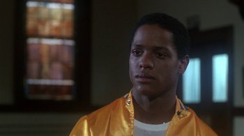 Movie still from “Krush Groove” (1985), directed by Michael Schultz – A man in a yellow jacket looking at the camera; Close Up shot, Low angle