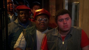 Movie still from “Krush Groove” (1985), directed by Michael Schultz – A group of men standing next to each other in a room; Close Up shot, High angle