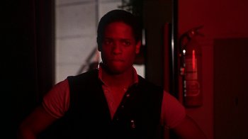 Movie still from “Krush Groove” (1985), directed by Michael Schultz – A man in a red shirt and a black vest; Close Up shot, Low angle