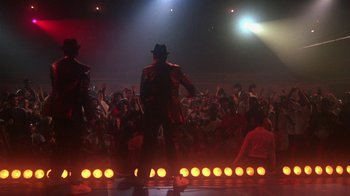 Movie still from “Krush Groove” (1985), directed by Michael Schultz – A crowd of people are watching a man in a hat; Wide shot, Low angle