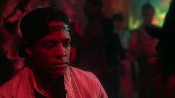 Movie still from “Krush Groove” (1985), directed by Michael Schultz – A young man in a red lit up room; Close Up shot, Over the shoulder angle