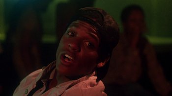 Movie still from “Krush Groove” (1985), directed by Michael Schultz – A man with a hat on and a surprised look on his face; Close Up shot, Low angle