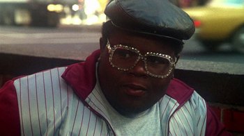 Movie still from “Krush Groove” (1985), directed by Michael Schultz – A man wearing a hat and glasses; Close Up shot, Low angle
