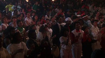 Movie still from “Krush Groove” (1985), directed by Michael Schultz – A group of people standing in front of a crowd; Medium shot, High angle